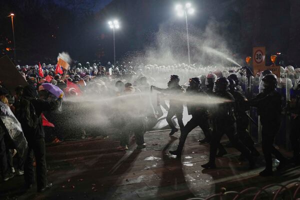 Riot police officers clash with protesters during a protest after Istanbul's Mayor Ekrem Imamoglu was arrested and sent to prison, in Istanbul, Turkey, Sunday, March 23, 2025. (AP Photo/Francisco Seco)