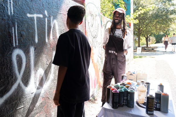 Malcolm Turpin works with Jonathan Contreras during one of his classes. “There is no literal school for graffiti," Turpin said.