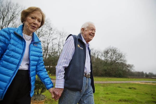 Former President Jimmy Carter, right, and his wife Rosalynn arrive for a ribbon cutting ceremony for a solar panel project on farmland he owns in their hometown of Plains, Ga., Wednesday, Feb. 8, 2017. Carter leased the land to Atlanta-based SolAmerica Energy, which owns, operates, and sells power generated from solar cells. The company estimates the project will provide more than half of the power needed in this town of 755 people. (AP Photo/David Goldman)