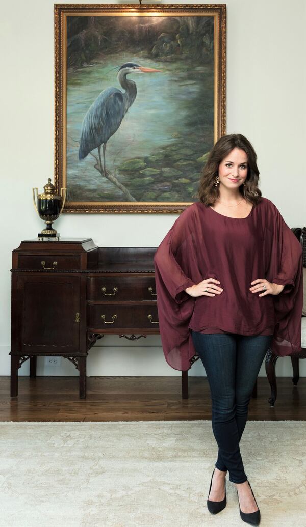  Pursell Farms is a family operation. Daughter Vaughan Pursell Spanjer, shown with one of her paintings, is the property's artist in residence.