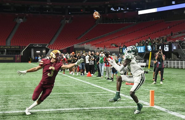 Collins Hill wide receiver Travis Hunter (12) turns back to find the ball in the end zone to score a touchdown against Brookwood during the 2021 Corky Kell Classic Saturday, Aug. 21, 2021, at Mercedes-Benz Stadium in Atlanta. (Hyosub Shin / Hyosub.Shin@ajc.com)