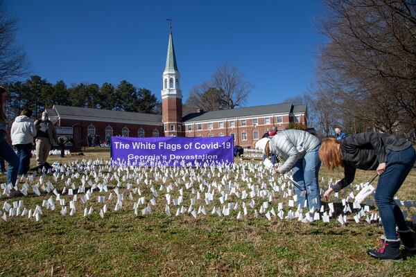 About 48 volunteers from 10 churches turned First Christian Church of Decatur, into a miniature Flanders Field, with row after row of white flags. (Photo: Steve Schaefer for The Atlanta Journal-Constitution)