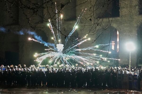 Fireworks thrown by protesters explode over riot police during a protest against the arrest of Istanbul's Mayor Ekrem Imamoglu, in Istanbul, Turkey, Saturday, March 22, 2025. (AP Photo/Khalil Hamra)