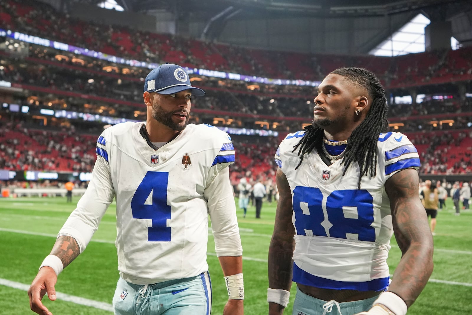 Dallas Cowboys quarterback Dak Prescott (4) walks off the field with wide receiver CeeDee Lamb (88) after an NFL football game against the Atlanta Falcons, Sunday, Nov. 3, 2024, in Atlanta. The Falcons won 27-21. (AP Photo/ Brynn Anderson)