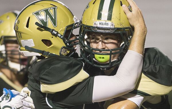 Wesleyan's Drew Aspinwall (left) congratulates Harrison Cook on a pass interception against Pace Academy Knights. (Phil Skinner/Special to AJC)