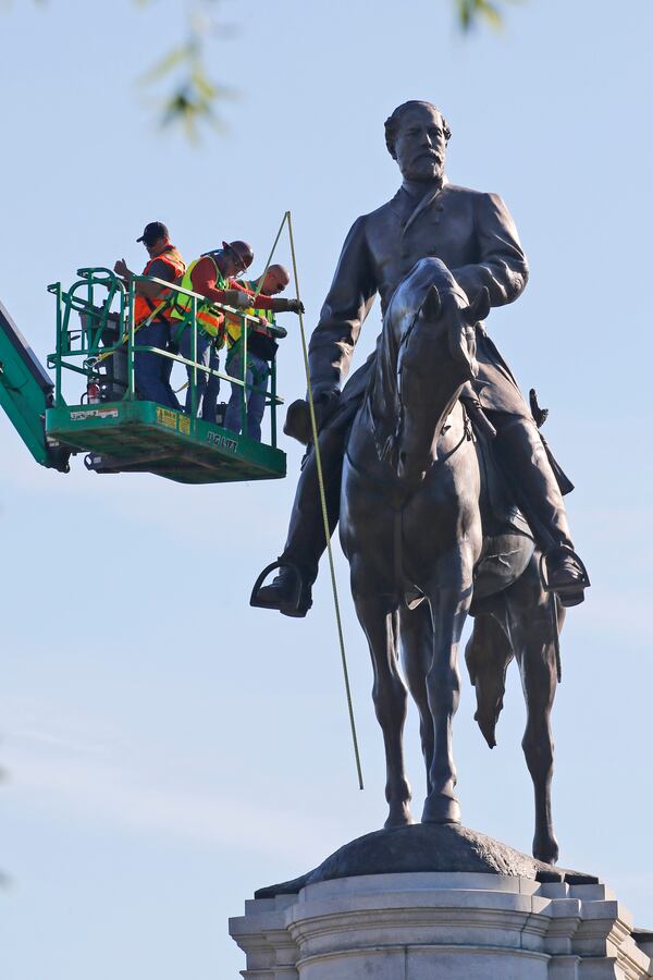 An inspection crew from the Virginia Department of General Services takes measurements as they inspect the statue of Confederate Gen. Robert E. Lee.