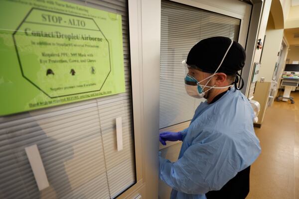 Northeast Georgia Medical Center registered nurse Dylan, in full PPE, enters a room to provide care to a patient with COVID-19 on Monday, February 5, 2024, Miguel Martinez /miguel.martinezjimenez@ajc.com.