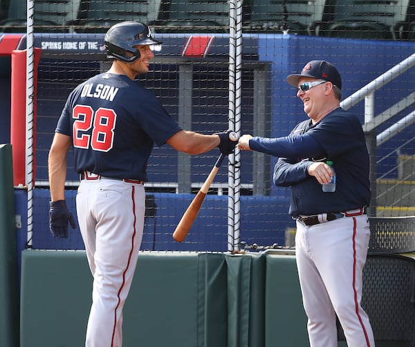 031622 North Port: Atlanta Braves newly signed first baseman Matt Olson gets a fist bump from hitting coach Kevin Seitzer after ripping a single off pitcher Charlie Morton during his first plate appearance with the team during live batting practice at Spring Training at CoolToday Park on Wednesday, March 16, 2022, in North Port.    “Curtis Compton / Curtis.Compton@ajc.com”