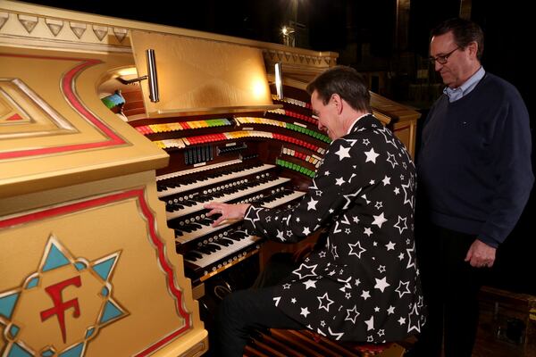 AJC reporter Bo Emerson gets a lesson at the Fox Theatre’s Mighty Möller pipe organ from Fox organist Ken Double. The console for the organ is undergoing a year-long renovation. Photo: Tyson Horne/tyson.horne@ajc.com