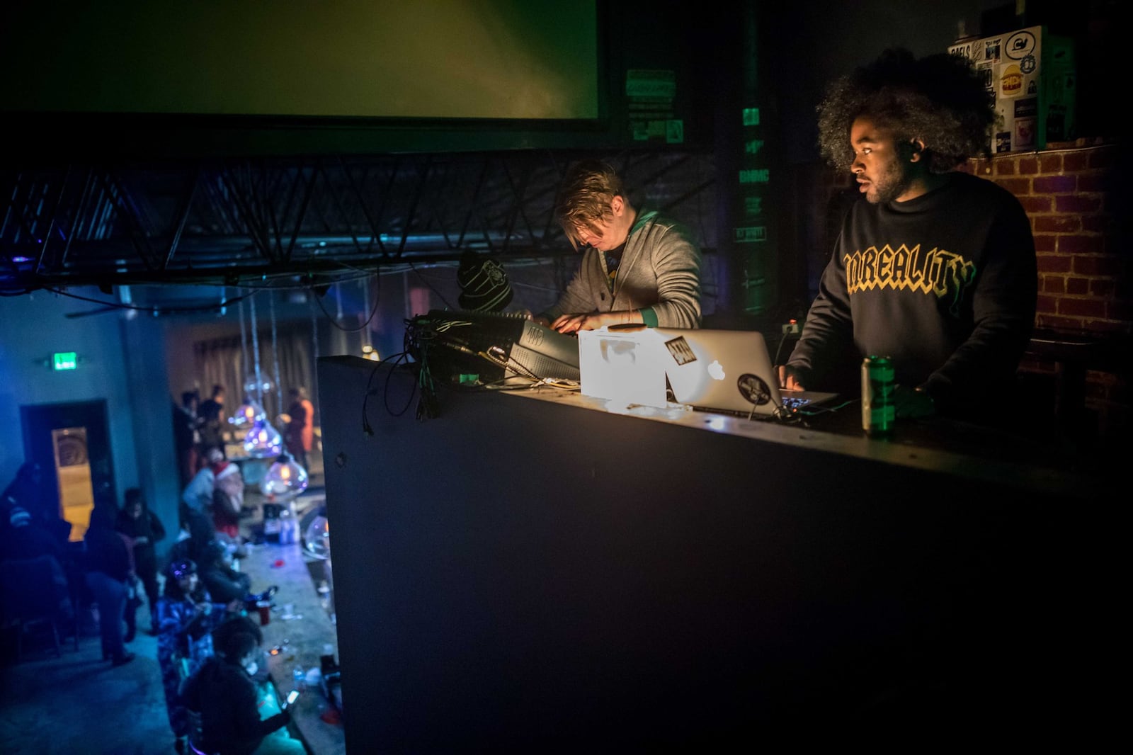 Sound engineer Sam Elgin (left) and Arkkade Kult work in the sound booth as punk rock band KillerKroc performs during a Punk Black event at Union EAV on Dec. 14, 2017. BRANDEN CAMP / SPECIAL