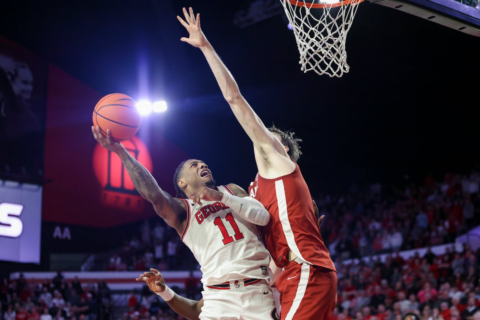 Georgia guard Justin Hill (11) attempts a shot against Alabama forward Grant Nelson (2) during the second half at Stegemen Coliseum, Wednesday, January 31, 2024, in Athens, Ga. (Jason Getz / jason.getz@ajc.com)