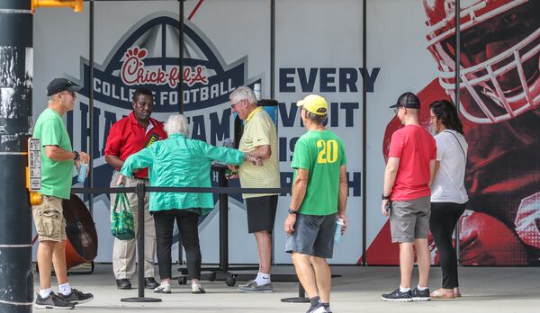 September 2, 2022 Atlanta: Oregon football fans line up outside the Chick-fil-A College Football Hall of Fame located at 250 Marietta Street  NW in downtown Atlanta as College football fans began filtering into downtown on Friday, Sept. 2, 2022 for Saturday’s big game with the defending College Football National Champions, the Georgia Bulldogs set to take on the #11 Oregon Ducks in the Chick-fil-A kickoff game at Mercedes-Benz Stadium. (John Spink / John.Spink@ajc.com)

