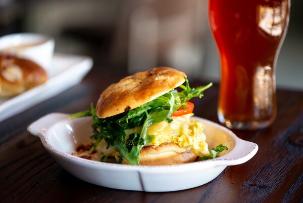 The Lost Druid "The Awakening" breakfast sandwich with bacon jam, scrambled eggs and white cheddar with tomato and arugula.