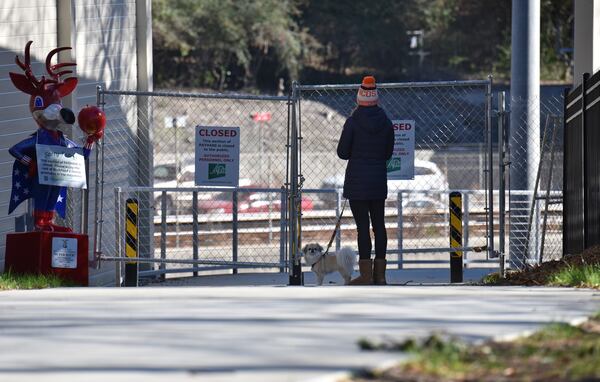 A resident stops at a new segment of PATH400, which is nearly complete but was still closed on Dec. 19, 2019. The PATH400 through Buckhead is broken into two pieces, but this new section slated to open early next year will connect them, completing the ride through one of the busiest parts of Atlanta. New links like this are being forged in broken paths across metro Atlanta to create a regional network that could serve as an alternative to roads. HYOSUB SHIN / HYOSUB.SHIN@AJC.COM