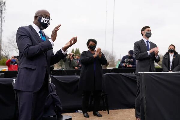 Raphael Warnock, left, and Stacey Abrams -- shown campaigning with Jon Ossoff -- will likely top the Democratic ticket in 2022, with Warnock seeking reelection to the U.S. Senate and Abrams pursuing a rematch against Gov. Brian Kemp.