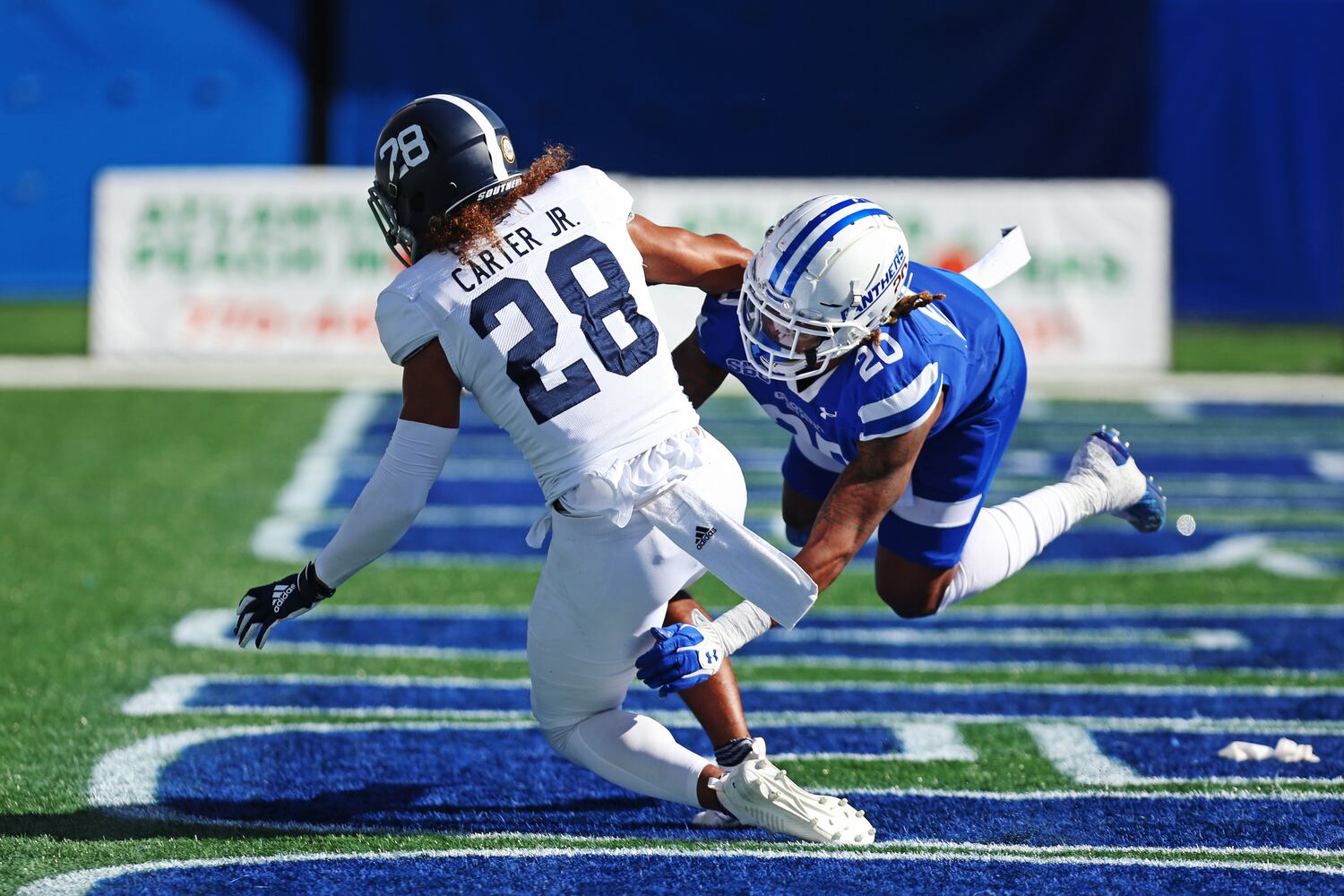 Quavian White of Georgia State (right)  tackles Dexter Carter Jr. of Georgia Southern. CHRISTINA MATACOTTA FOR THE ATLANTA JOURNAL-CONSTITUTION