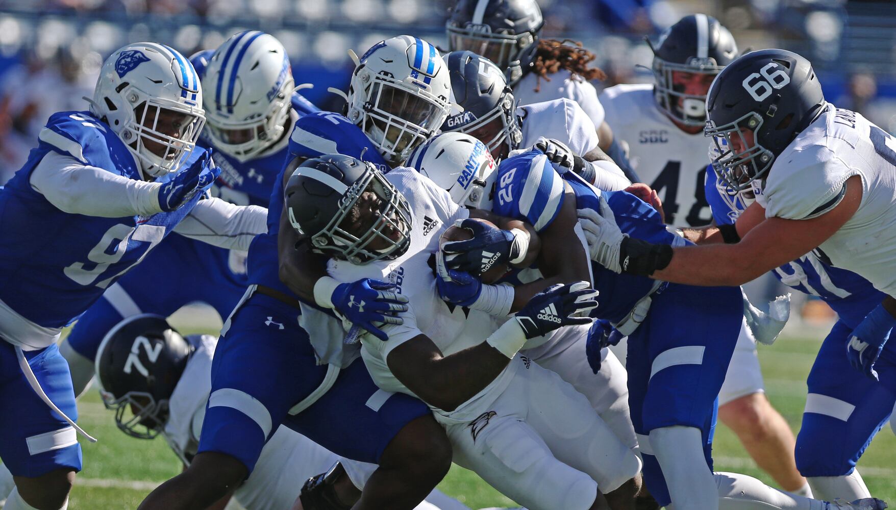 Gerald Green of Georgia Southern, gets tackled by the Georgia State defense. CHRISTINA MATACOTTA FOR THE ATLANTA JOURNAL-CONSTITUTION