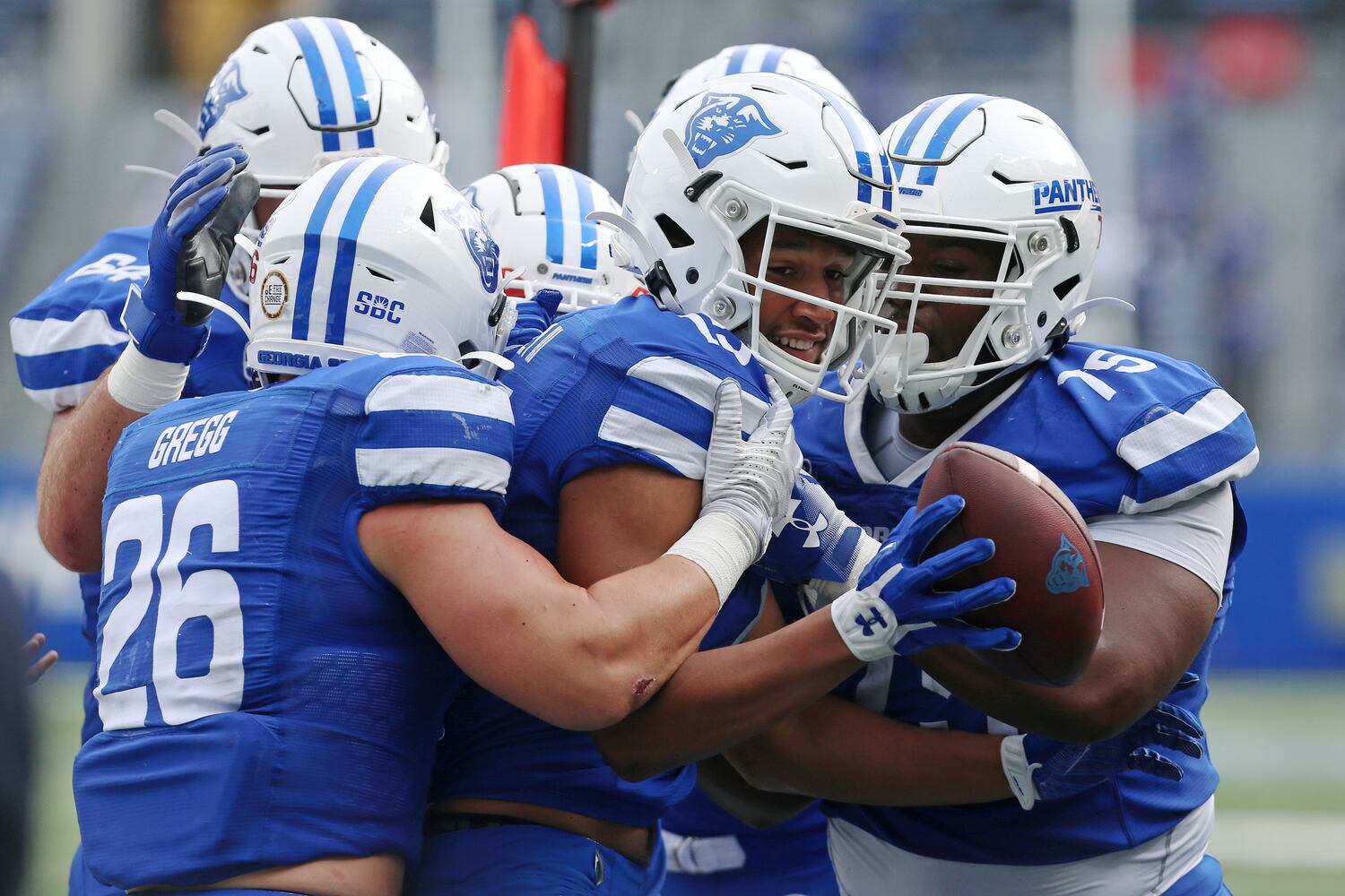 Sam Pinckney is surrounded by his Georgia State teammates, after scoring a touchdown.. CHRISTINA MATACOTTA FOR THE ATLANTA JOURNAL-CONSTITUTION