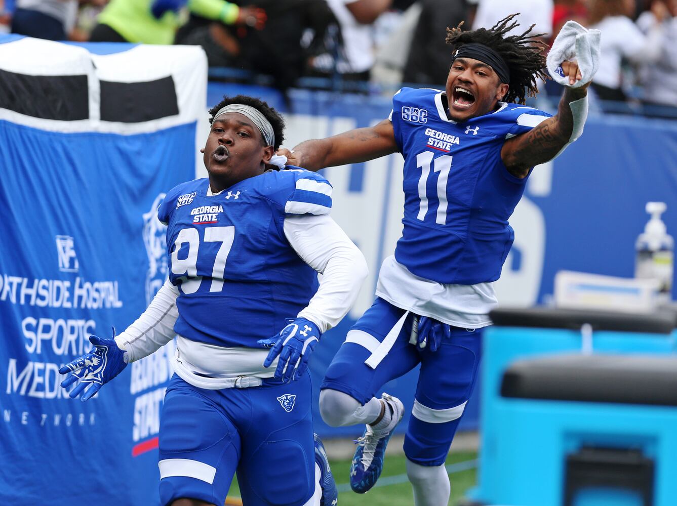 Georgia State's Akeem Smith and Caddarrius Thompson celebrate after a fumble recovery. CHRISTINA MATACOTTA FOR THE ATLANTA JOURNAL-CONSTITUTION