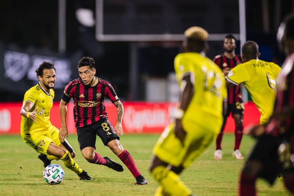 Atlanta United's Ezequiel Barco (8) attempts to penetrate the Columbus defense Tuesday, July 21, 2020, during MLS tournament in Orlando, Fla.