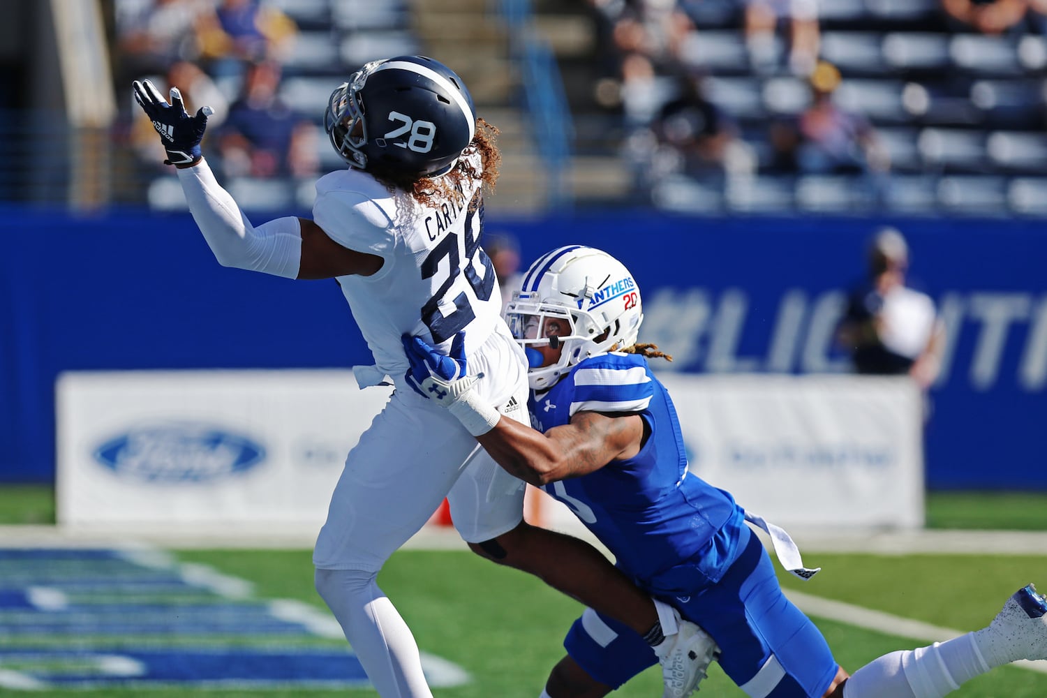 Georgia State's Quavian White (right) tackles Dexter Carter Jr. of Georgia Southern. CHRISTINA MATACOTTA FOR THE ATLANTA JOURNAL-CONSTITUTION