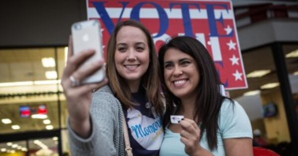 Lauren Koepp and Kara Smyth pose for a photo after casting their votes on Election Day early Tuesday morning, Nov. 4, 2014 in Austin, Texas. (AP Photo/Tamir Kalifa)