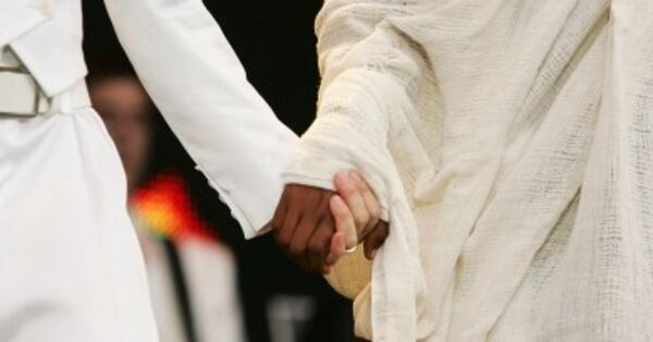 LONDON - JULY 02: Singer Madonna holds hands with Birhan Woldu on stage at 