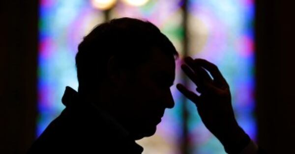 A man receives ashes from Baltimore Archbishop William Lori during an Ash Wednesday Mass, Wednesday, Feb. 18, 2015, in Baltimore. Ash Wednesday marks the start of the Lent, a season of prayer and fasting for Christians before Easter. (AP Photo/Patrick Semansky)