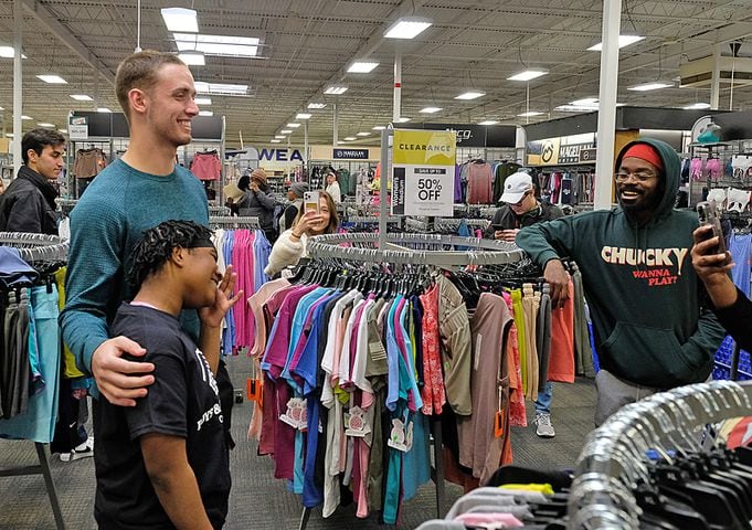 KiMarri Risper, 12 poses with UGA Quarterback Carson Beck who was on site at an Athen Academy store Sunday December 17, 2023, to give out gift cards to lucky members of area Boys and Girls Clubs. Academy Sports and Outdoors contributed $200 for each child and he kicked in $135 more of his own money to help families out. 

credit: Nell Carroll for the AJC