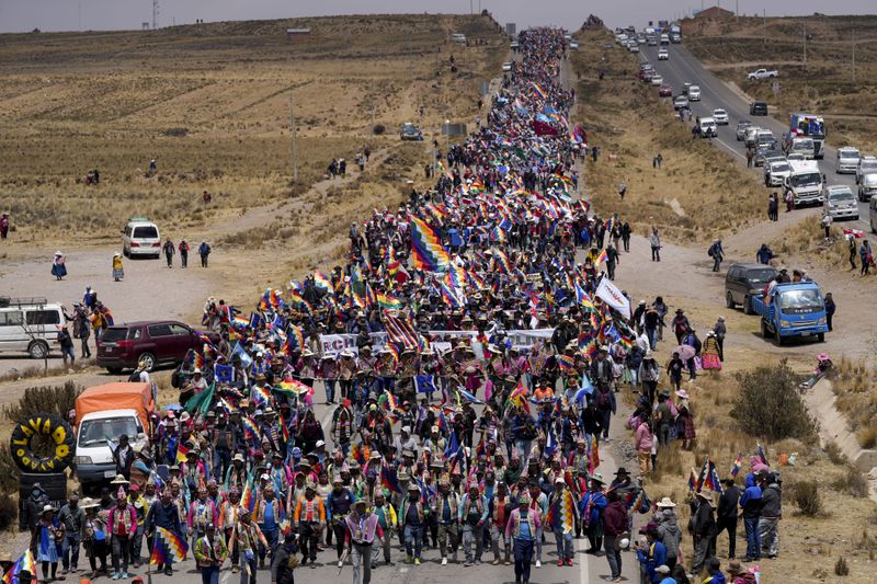 Supporters of former President Evo Morales march to the capital to protest the government of current President Luis Arce near El Alto, Bolivia, Sunday, Sept. 22, 2024. (AP Photo/Juan Karita)