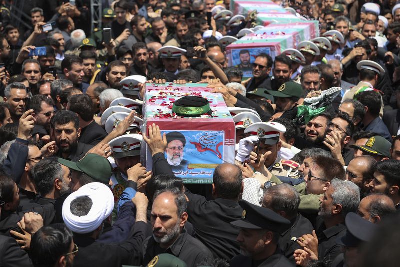 In this photo released by the Iranian Presidency Office, flag-draped coffins of the President Ebrahim Raisi and his companions who were killed in a helicopter crash on Sunday, during their funeral ceremony in the city of Mashhad, Iran, Thursday, May 23, 2024. Iran on Thursday prepared to inter its late president at the holiest site for Shiite Muslims in the Islamic Republic, a final sign of respect for a protégé of Iran's supreme leader killed in a helicopter crash earlier this week. (Iranian Presidency Office via AP)
