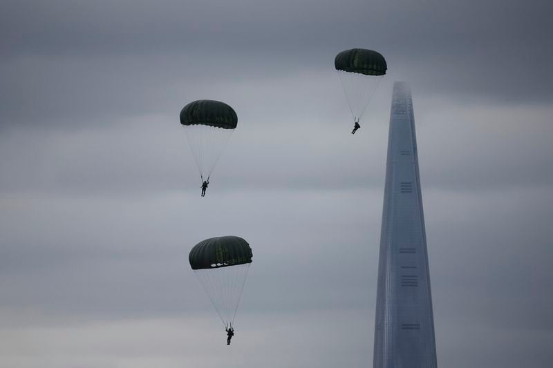 Members of the Special Warfare Command parachute as 123-storey skyscraper Lotte World Tower is seen in the background during a celebration to mark 76th anniversary of Korea Armed Forces Day, in Seongnam, South Korea, Tuesday, Oct.1, 2024. (Kim Hong-Ji/Pool Photo via AP)