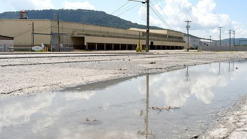 A puddle lingers along the edge of Alton Park Boulevard, just off Market Street, in Chattanooga, Tennessee. The Alton Park area is a victim of the urban heat island effect, a phenomenon where dense concrete development in tandem with limited tree canopy causes an area to be warmer than it would be. (Photo Courtesy of Robin Rudd)