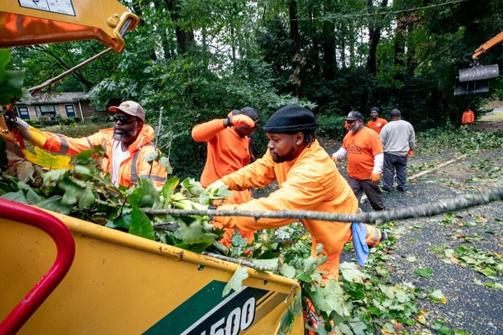 City of Decatur Public Works teams remove hurricane Helene damage from the 1000 block of Scott Blvd on Friday, Sept 27, 2024.  The team took care of six trees before noon, fewer than expected.  (Jenni Girtman for The Atlanta Journal-Constitution)