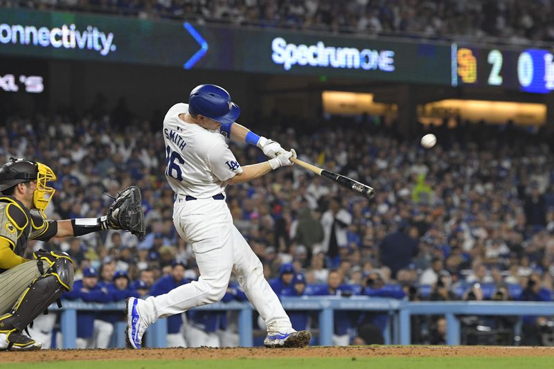 Los Angeles Dodgers' Will Smith hits a two-run home run during the seventh inning of a baseball game against the San Diego Padres, Thursday, Sept. 26, 2024, in Los Angeles. (AP Photo/Mark J. Terrill)