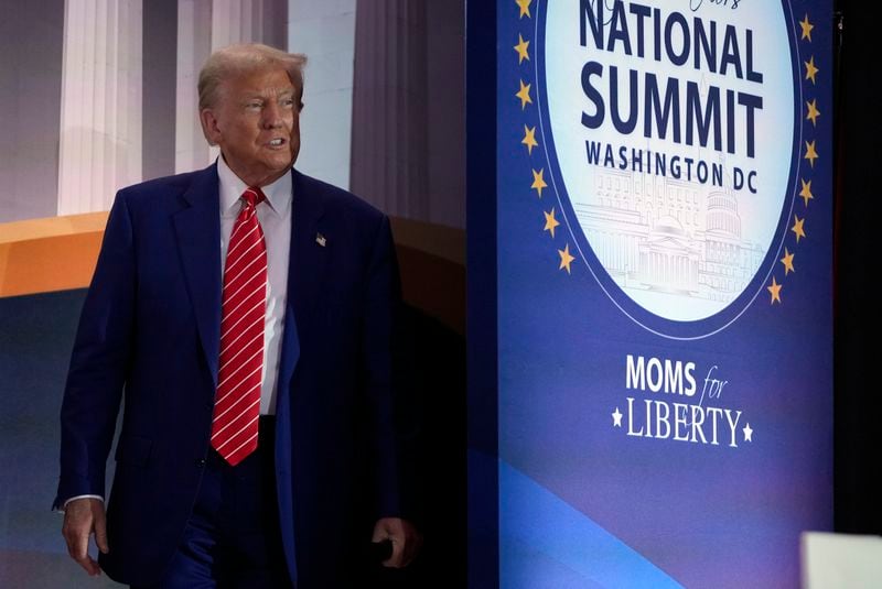 Republican presidential nominee former President Donald Trump arrives to speak with Moms for Liberty co-founder Tiffany Justice during an event at the group's annual convention in Washington, Friday, Aug. 30, 2024. (AP Photo/Mark Schiefelbein)