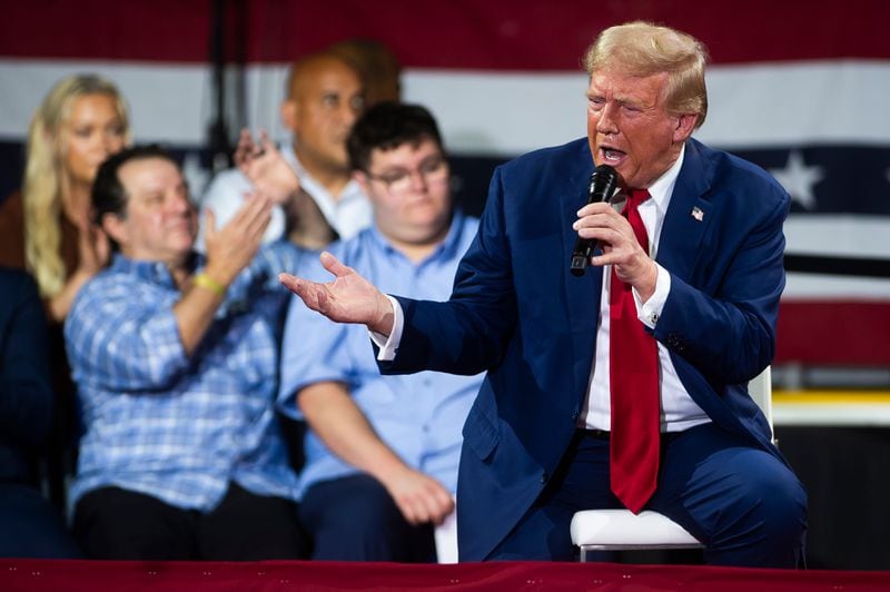 Former President Donald Trump speaks to supporters during a town hall on Tuesday in Flint, Michigan. He will be in New York today.