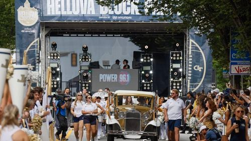 The Ramblin' Wreck makes its way down North Avenue ahead of the team.  DJ Envy held the first pregame concert at Georgia Tech’s new "Helluva Block Party".  North Avenue was closed before the football game vs South Carolina State for the event in Atlanta on Saturday, September 9, 2023.   (Bob Andres for the Atlanta Journal Constitution)