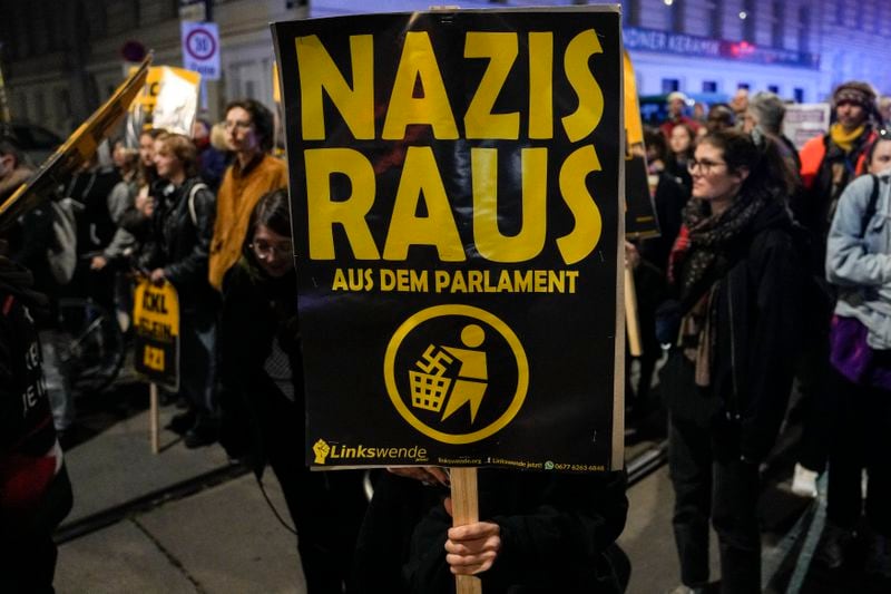 Anti right wing protesters shout slogans and hold banners that read "Nazis Out of the Parliament" outside the parliament building, in Vienna, Austria, Sunday, Sept. 29, 2024, after polls closed in the country's national election. (AP Photo/Andreea Alexandru)