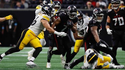 Atlanta Falcons running back Bijan Robinson (7) breaks a tackle during the second half of an NFL football game against the Pittsburgh Steelers on Sunday, Sept. 8, at Mercedes-Benz Stadium in Atlanta. 
(Miguel Martinez/ AJC)