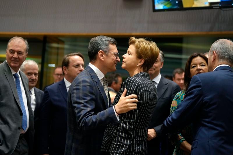 Ukraine's Foreign Minister Dmytro Kuleba, center left, greets Latvia's Foreign Minister Baiba Braze, center right, during a meeting of EU foreign ministers at the European Council building in Brussels, Thursday, Aug. 29, 2024. (AP Photo/Virginia Mayo)