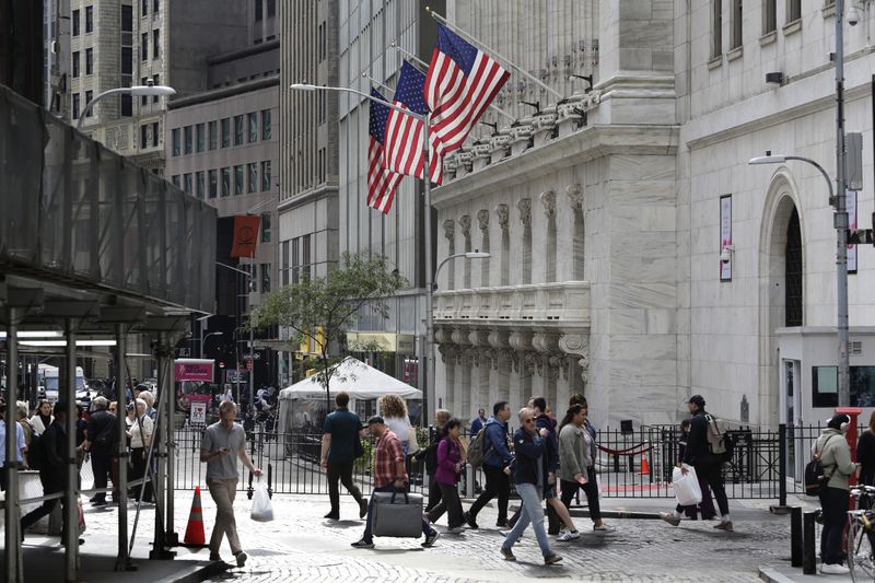 FILE - People pass the New York Stock Exchange on Oct. 1, 2024, in New York. (AP Photo/Peter Morgan, File)