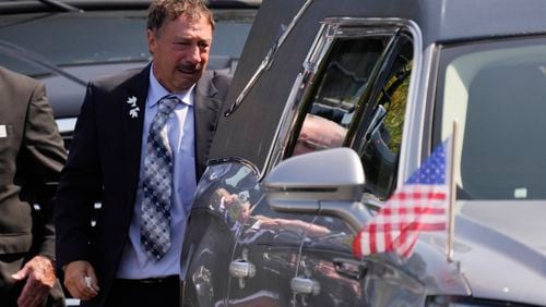 Guy Gaudreau looks into a hearse containing the remains of his son Columbus Blue Jackets hockey player John Gaudreau after his and his brother's Matthew Gaudreau funeral at St. Mary Magdalen Catholic Church in Media, Pa., Monday, Sept. 9, 2024. (AP Photo/Matt Rourke)