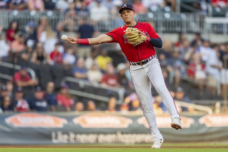 Atlanta Braves third baseman Gio Urshela throws out a Washington Nationals runner at first base in the first inning of a baseball game Friday, Aug. 23, 2024, in Atlanta. (AP Photo/Jason Allen)