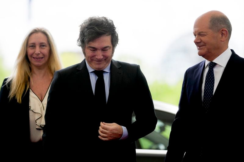 German Chancellor Olaf Scholz, right, welcomes Argentina's President Javier Milei, center, and his sister Karina Milei for a meeting at the chancellery in Berlin, Germany, Sunday, June 23, 2024. (AP Photo/Markus Schreiber)