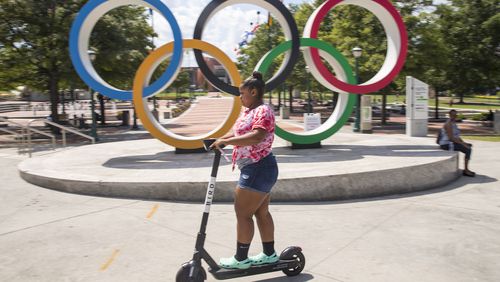 08/20/2019 -- Atlanta, Georgia -- A woman rides a sharable e-scooter near Centennial Olympic Park in Atlanta, Tuesday, August 20, 2019. (Alyssa Pointer/alyssa.pointer@ajc.com)