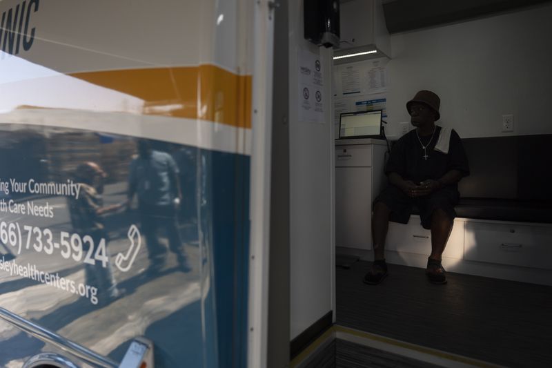 Kevin McCoy visits Wesley Health Centers' mobile clinic for his medical services in the Skid Row area of Los Angeles, Tuesday, Aug. 27, 2024. (AP Photo/Jae C. Hong)