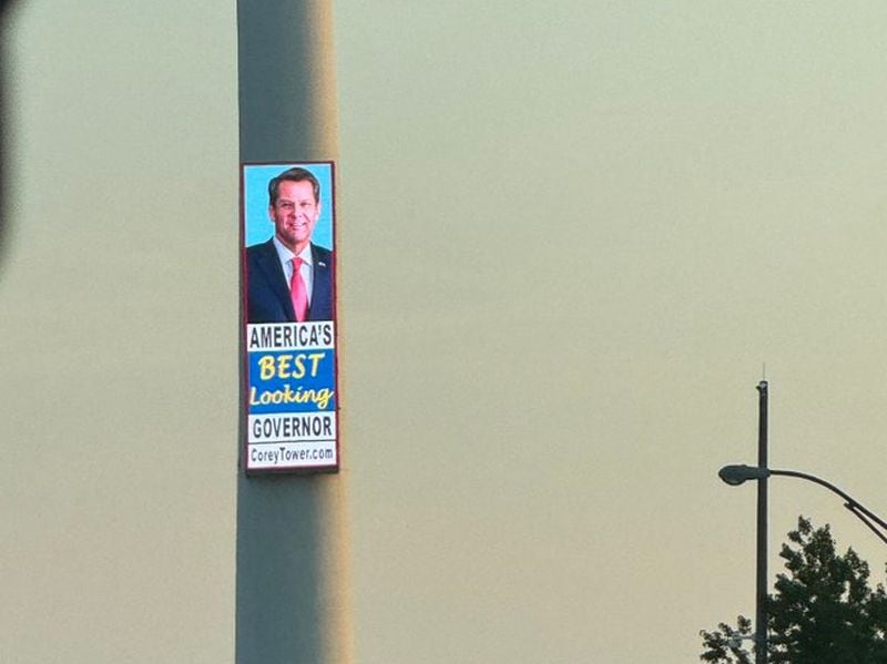 Bill Corey, who owns a 300-foot smokestack towering over the Downtown Connector, uses a digital billboard to promote Gov. Brian Kemp.