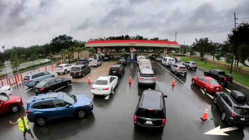 Cars wait in line to get into the parking lot for gas at Costco, Monday, Oct. 7, 2024, in Altamonte Springs, Fla., as residents prepare for the impact of approaching Hurricane Milton. (Joe Burbank/Orlando Sentinel via AP)