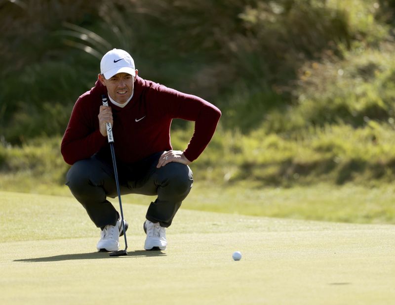 Northern Ireland's Rory McIlroy lines up his putts on the 5th green during day one of the Amgen Irish Open 2024 at Royal County Down in Newcastle, Ireland, Thursday Sept. 12, 2024. (Liam McBurney/PA via AP)